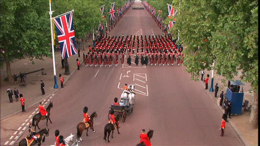 The Queen follows the Massed Bands and leads the Foot Guards up The Mall to Buckingham Palace